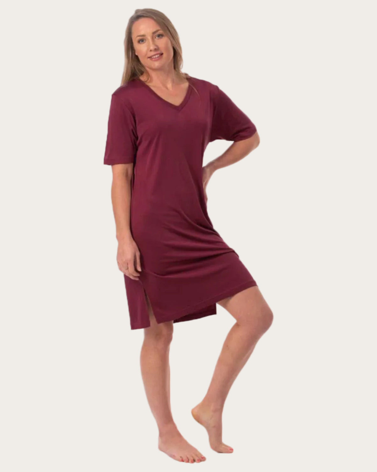 Woman wearing a merlot white background silk nightshirt 