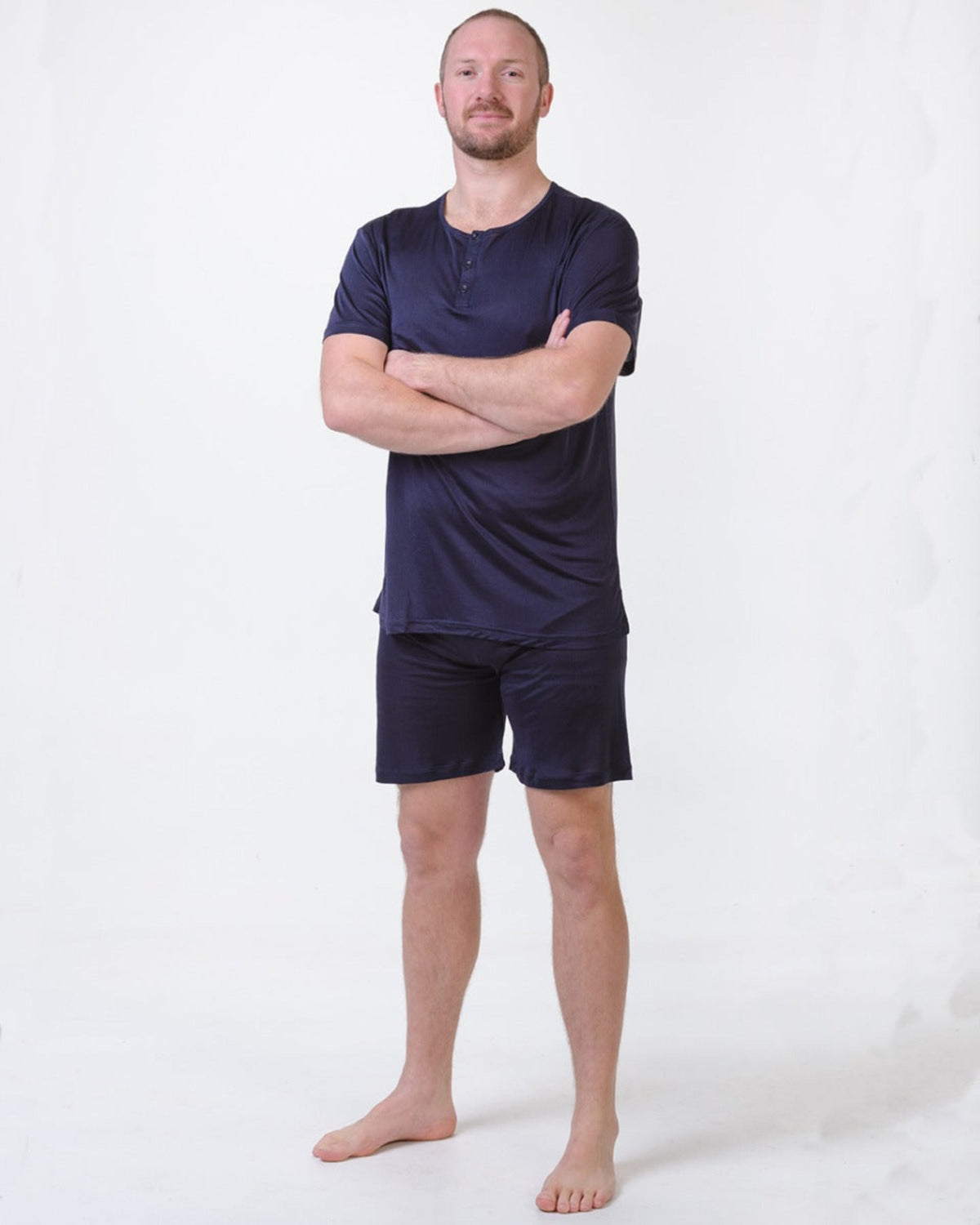 Man wearing a silk midnight  blue shirt and shorts 