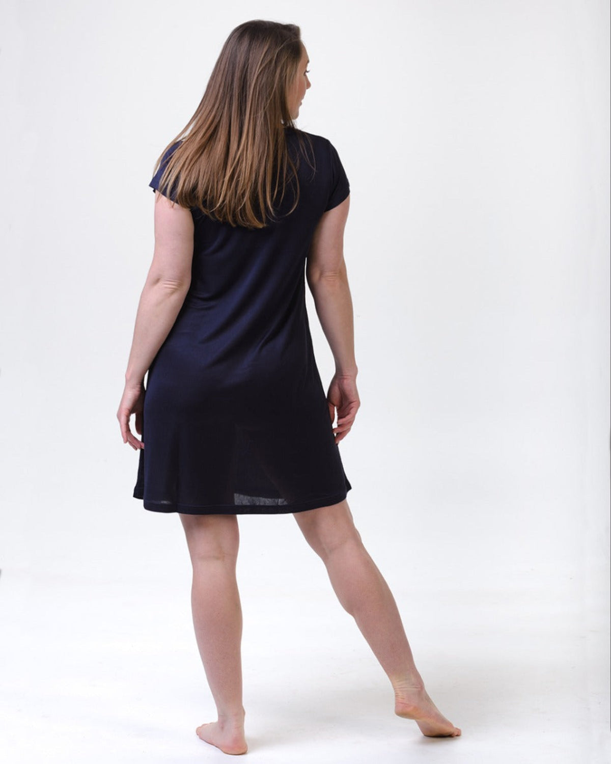 Woman wearing a midnight blue silk nightie  