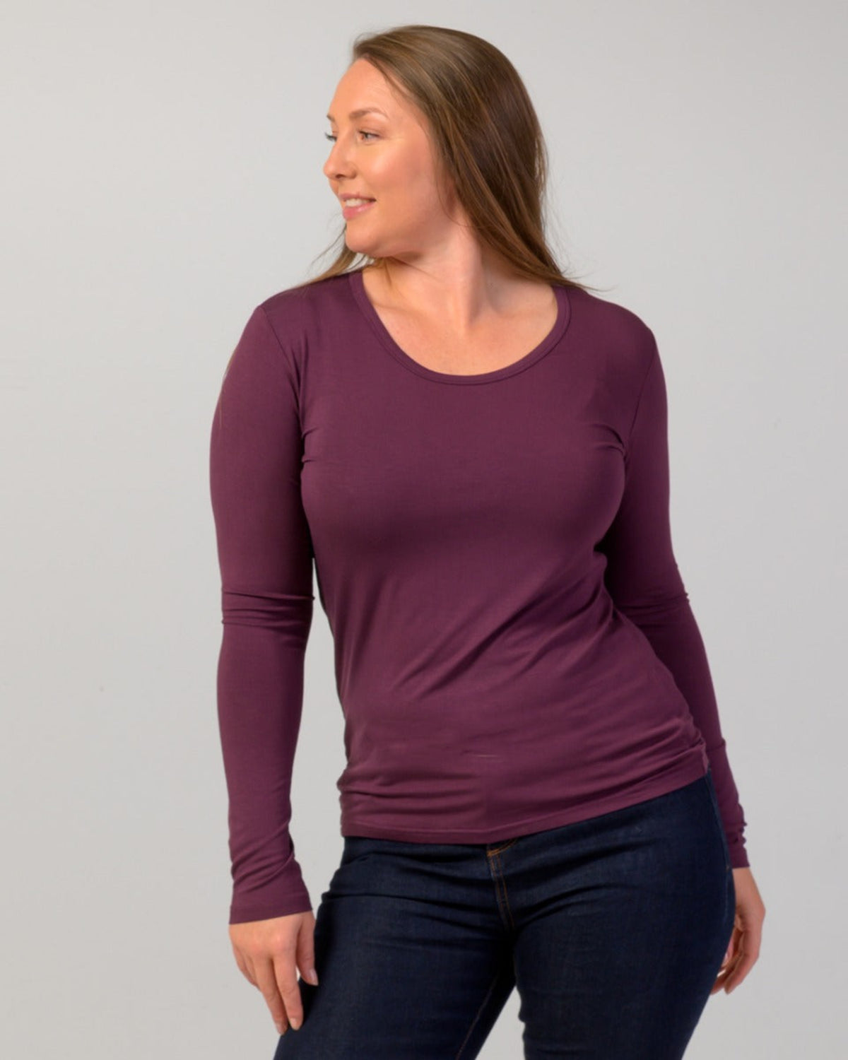 Woman wearing a purple long-sleeve bamboo shirt against a gray background