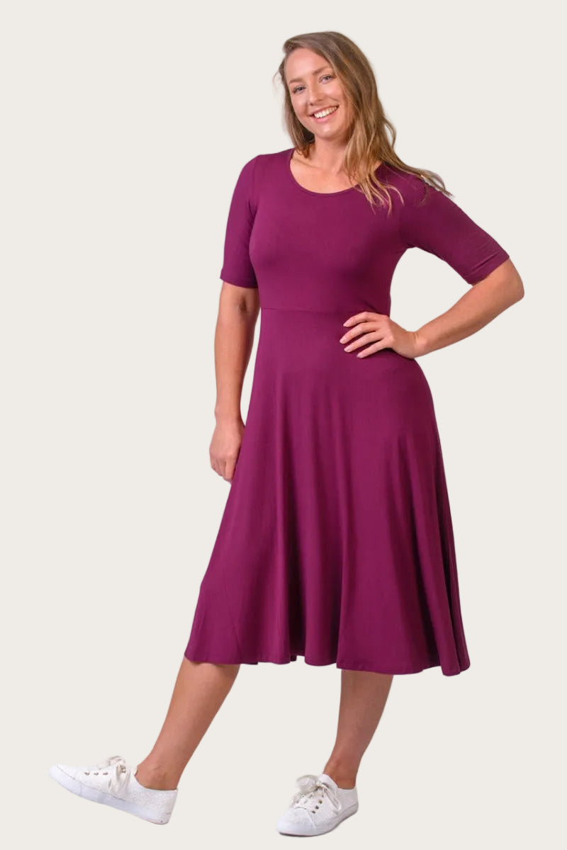 Woman wearing a purple dress on a white background