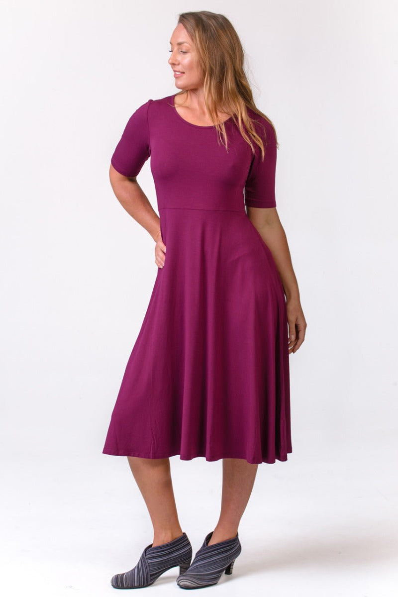 Woman wearing a purple dress on a white background