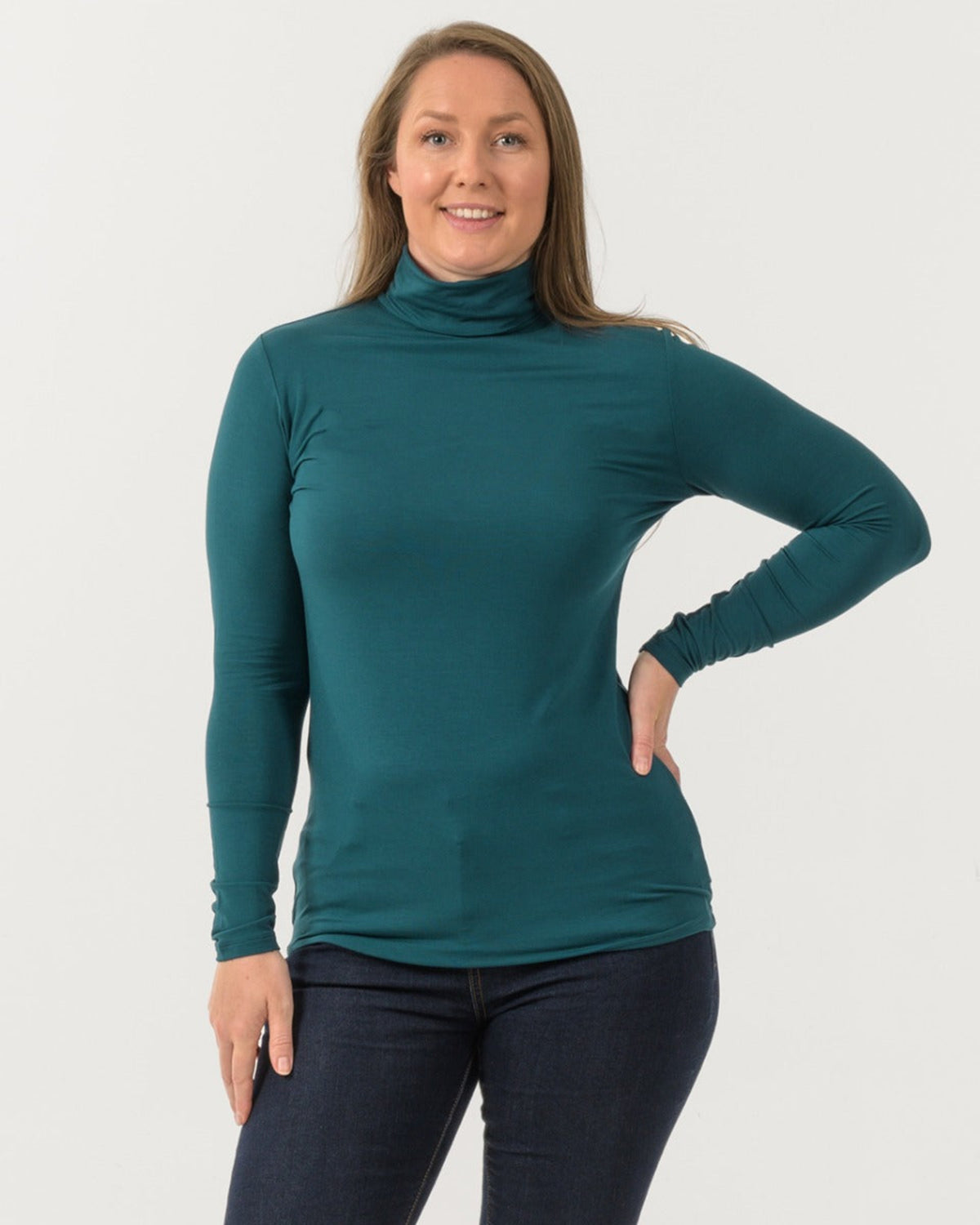 Bamboo Woman wearing a teal turtleneck shirt against a white background