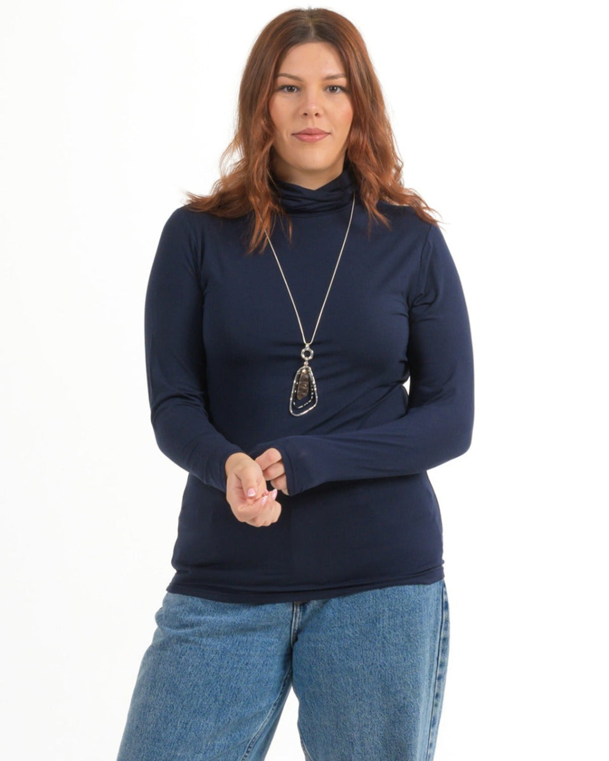 Bamboo Woman wearing a navy blue turtleneck sweater and jeans on a white background