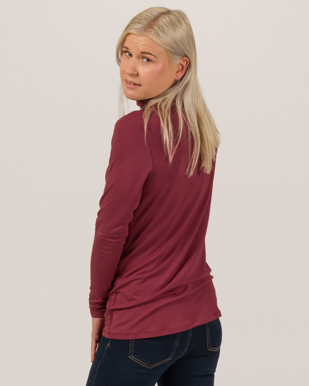 Bamboo Woman wearing a burgundy long-sleeve top against a plain background