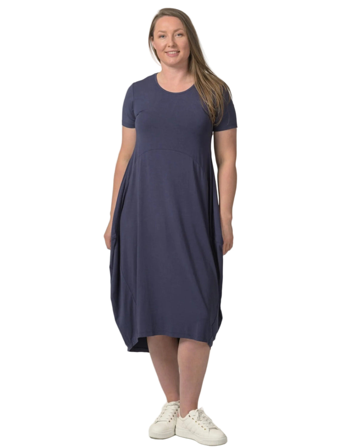 Woman wearing a navy bamboo cocoon blue dress on a white background