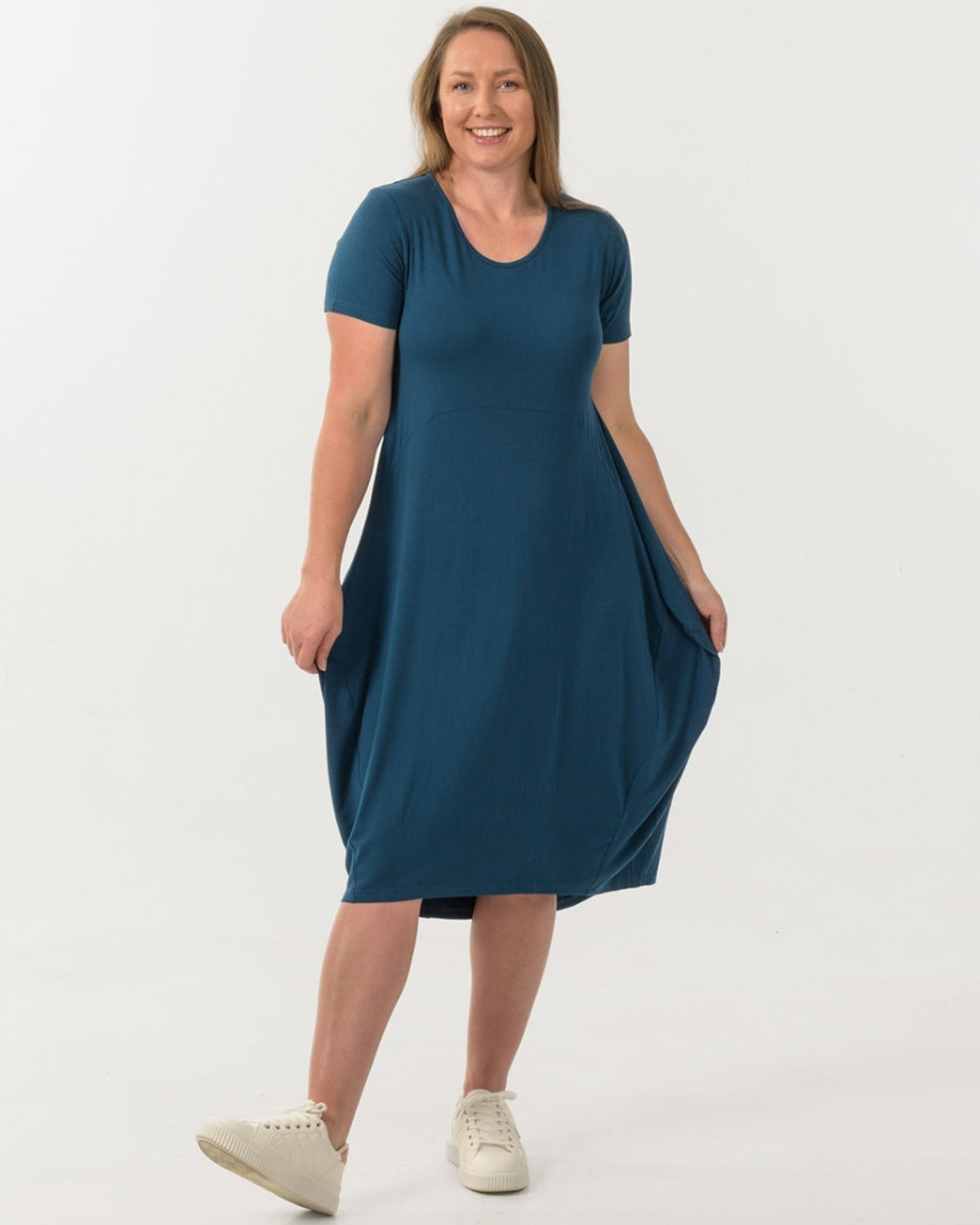 Woman bamboo cocoon  wearing a teal dress on a white background
