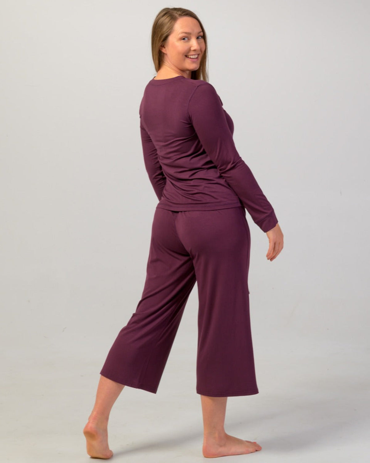 Woman wearing a eggplant  long-sleeve pajama top bamboo