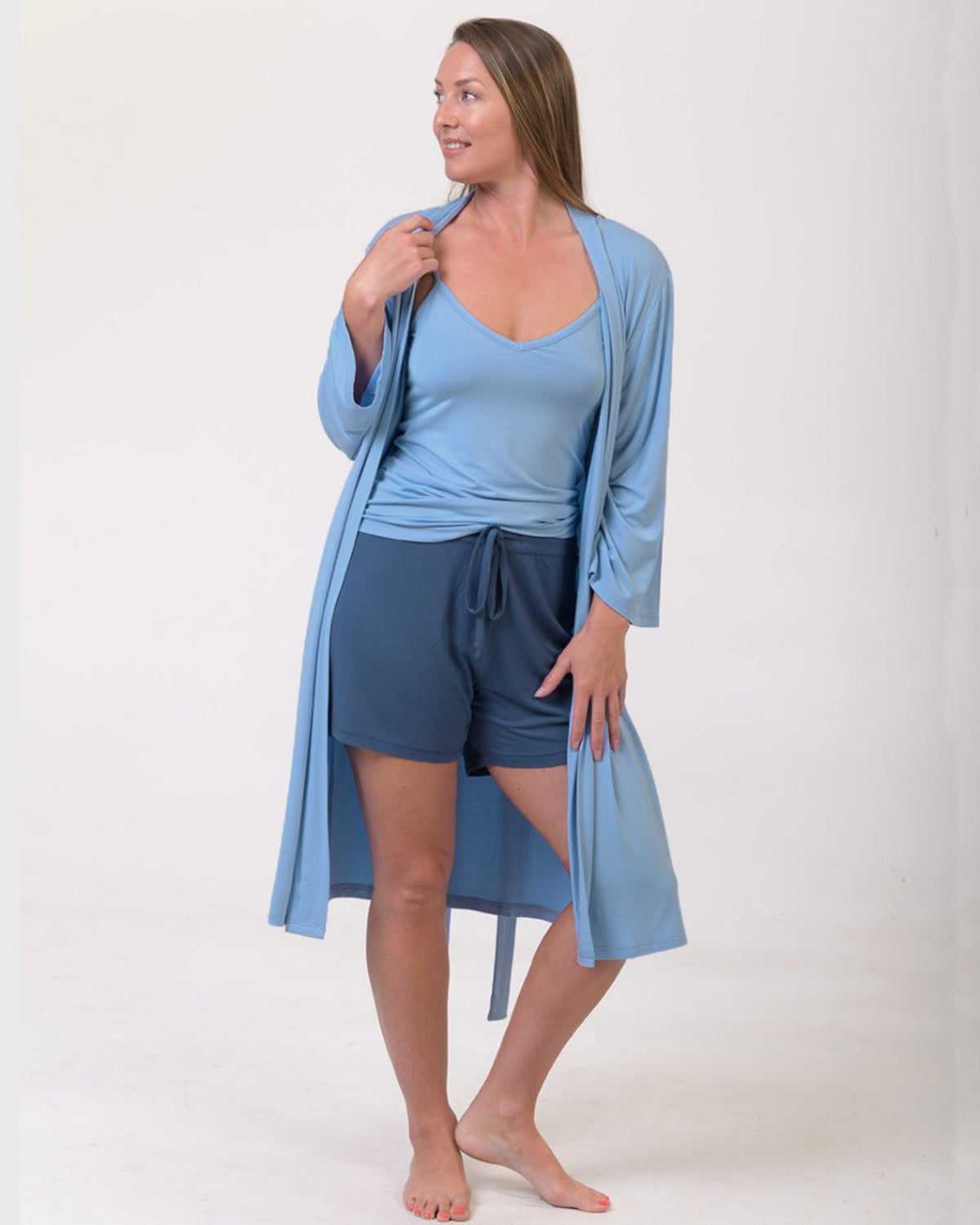 Woman wearing a light blue bamboo knee length robe 