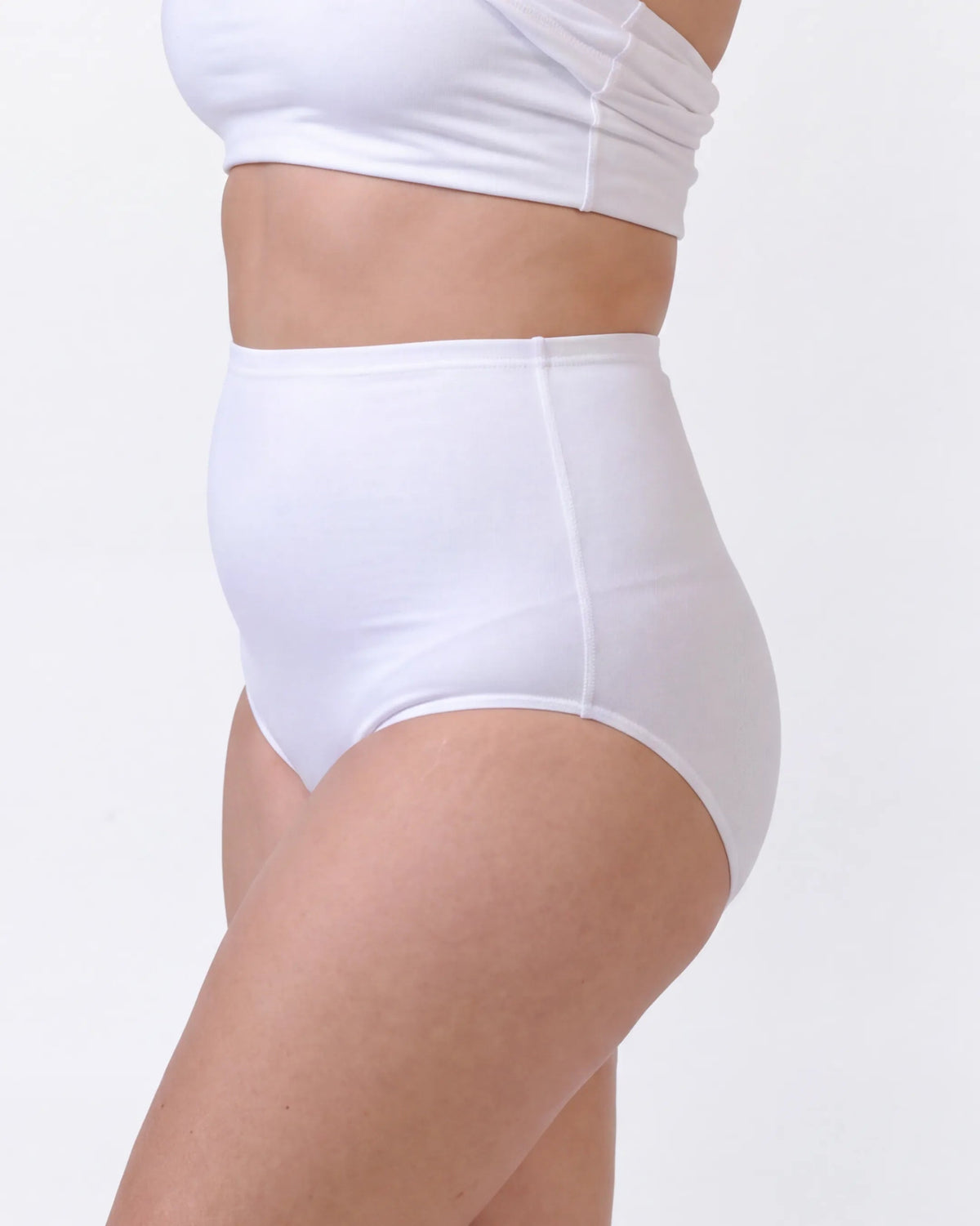 White high-waisted briefs worn by a model, shown from the waist down against a plain white background.