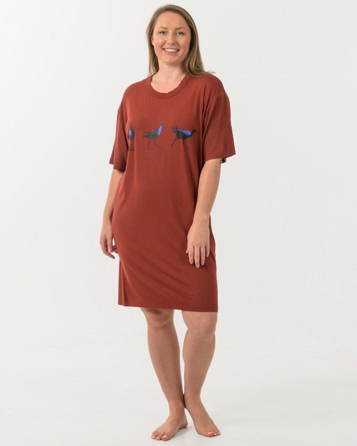 Bamboo Woman wearing a rust-colored nightshirt with a graphic design on a white background