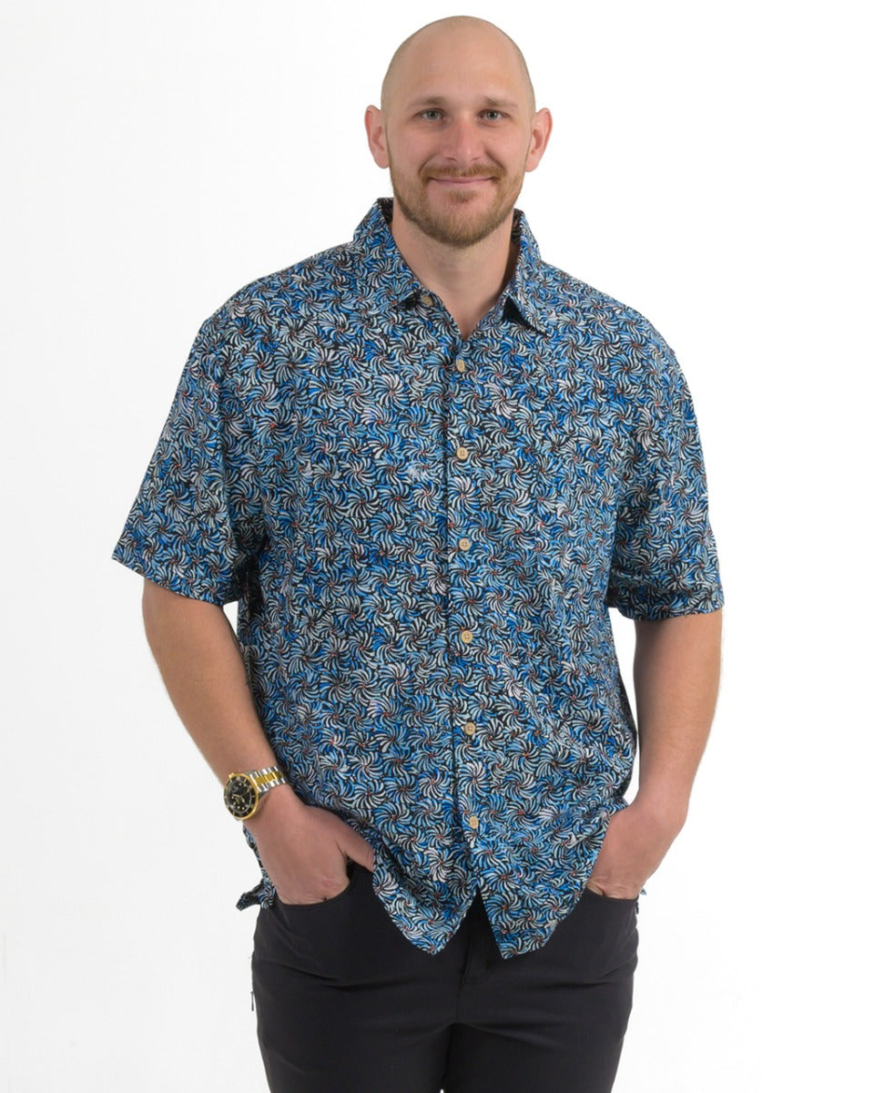Man wearing a blue patterned shirt on a white background