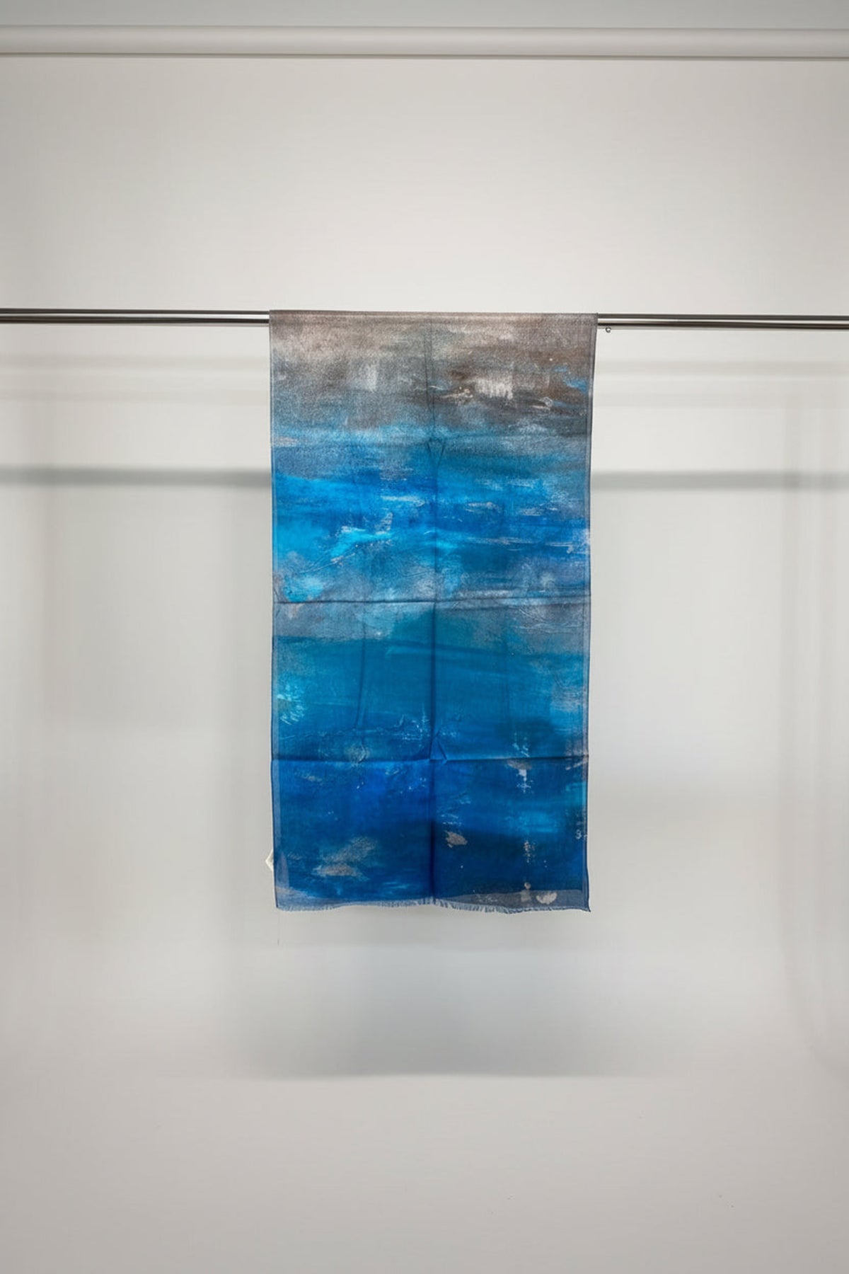 Blue and gray abstract patterned fabric on a metal rack