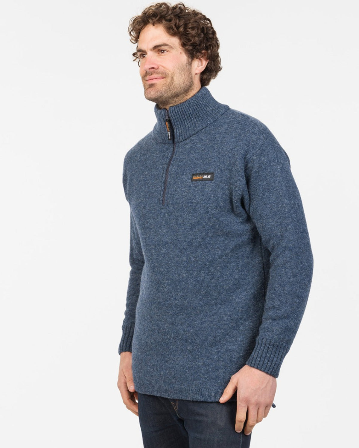 possum merino Man wearing a blue sweater with a brand logo on a white background