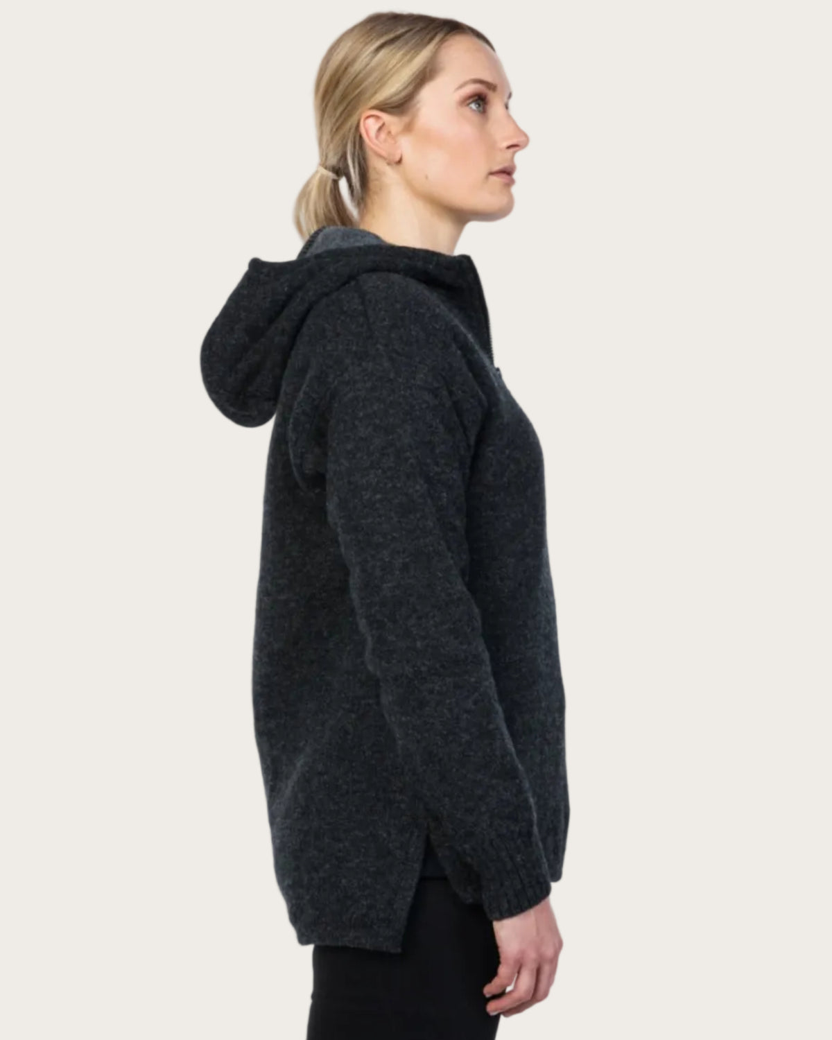Woman wearing a dark gray hooded jacket on a white background