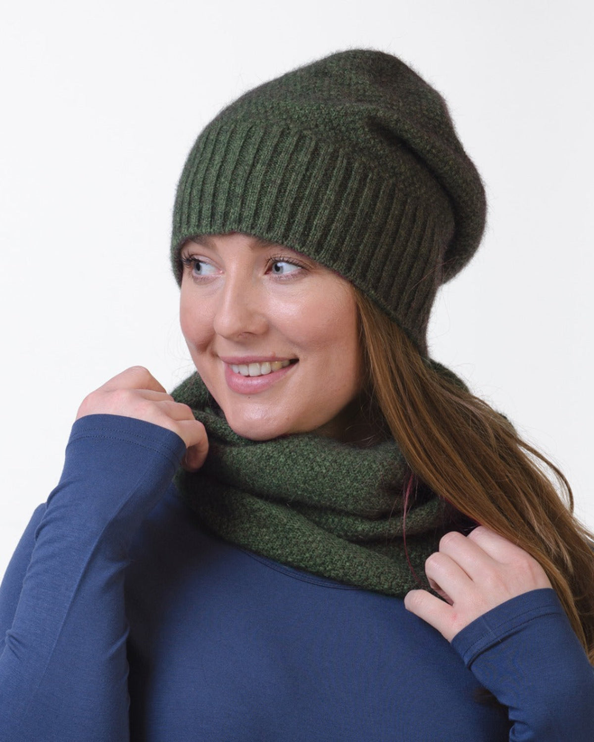 possum merino neck warmer Woman wearing a green knitted beanie and scarf on a white background