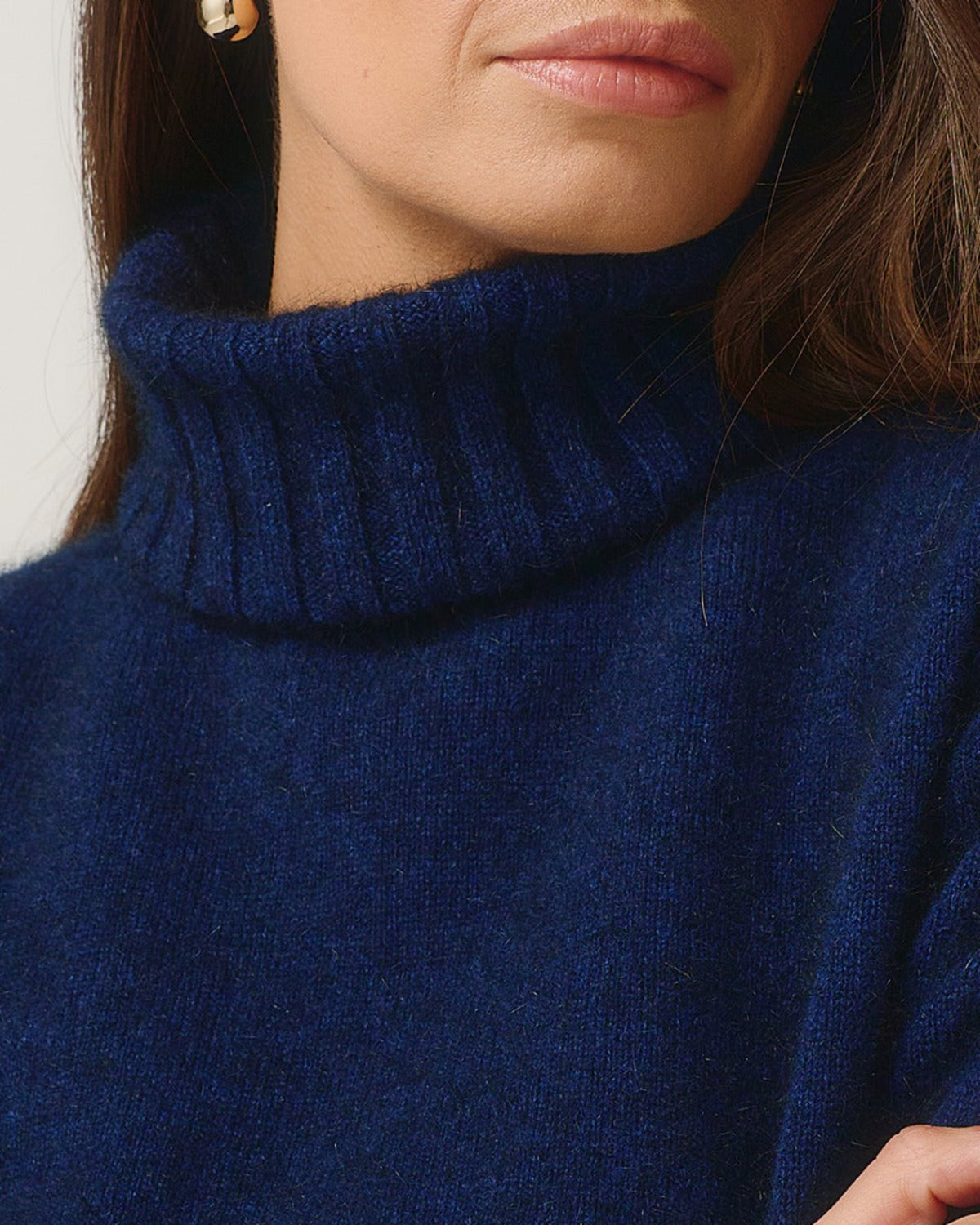 Possum Merino Close-up of a person wearing a blue turtleneck sweater.