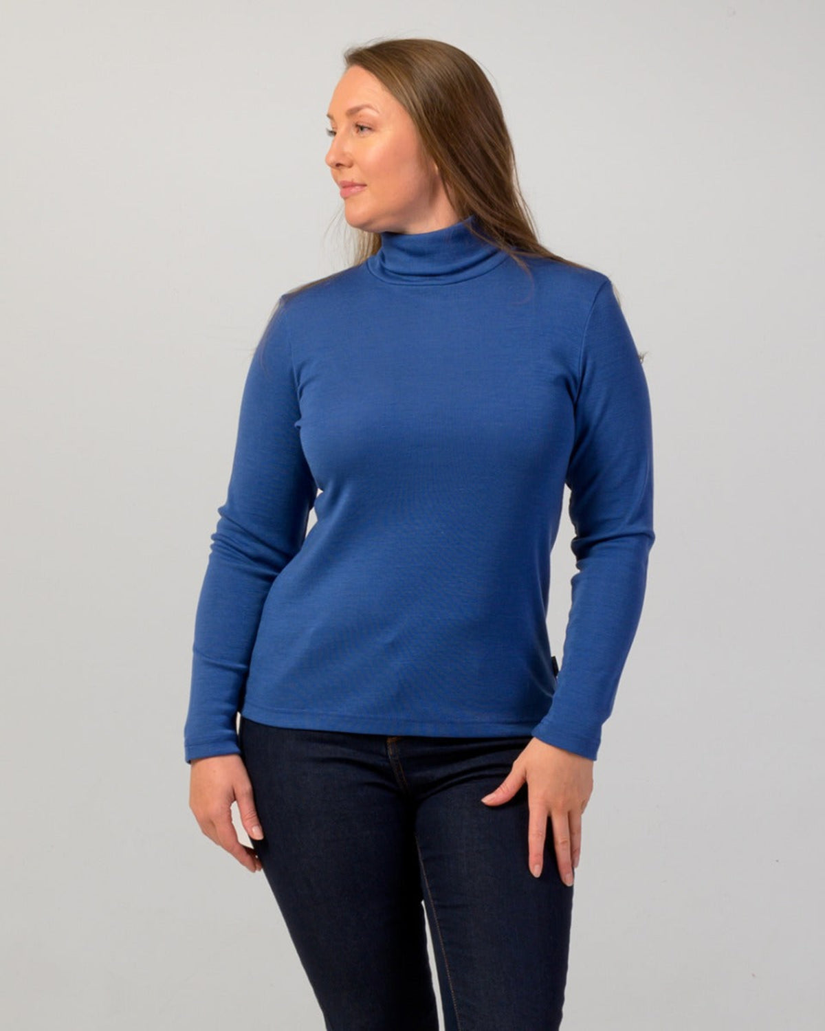 Woman wearing a merino roll neck  turtleneck sweater 