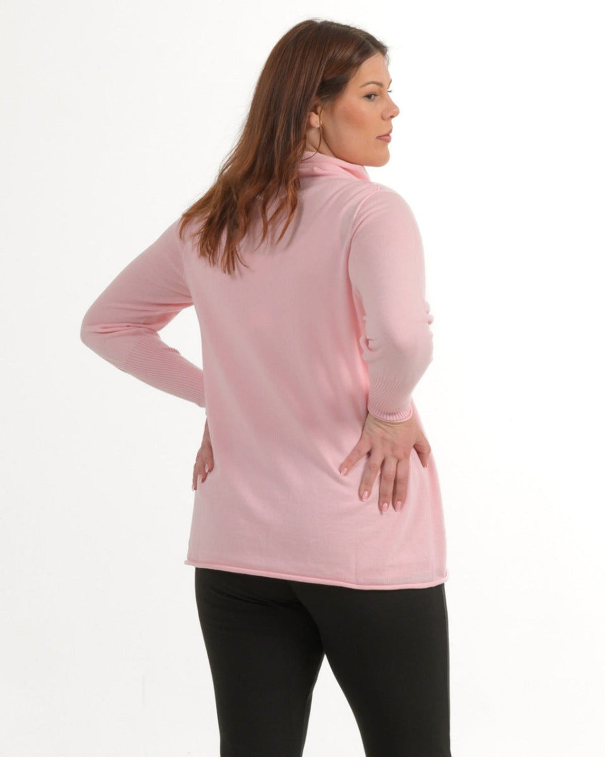 Woman wearing a pink long-sleeve merino top on a white background