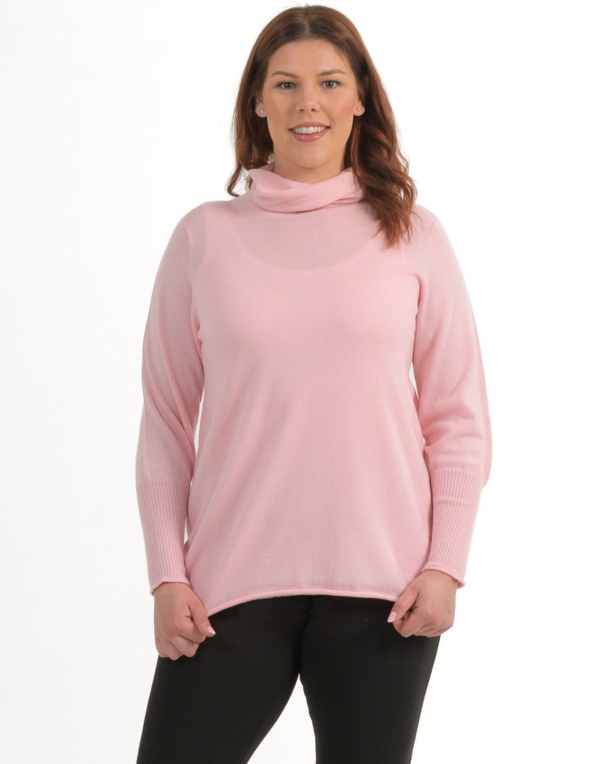 Woman wearing a pink merino  long-sleeve top on a white background