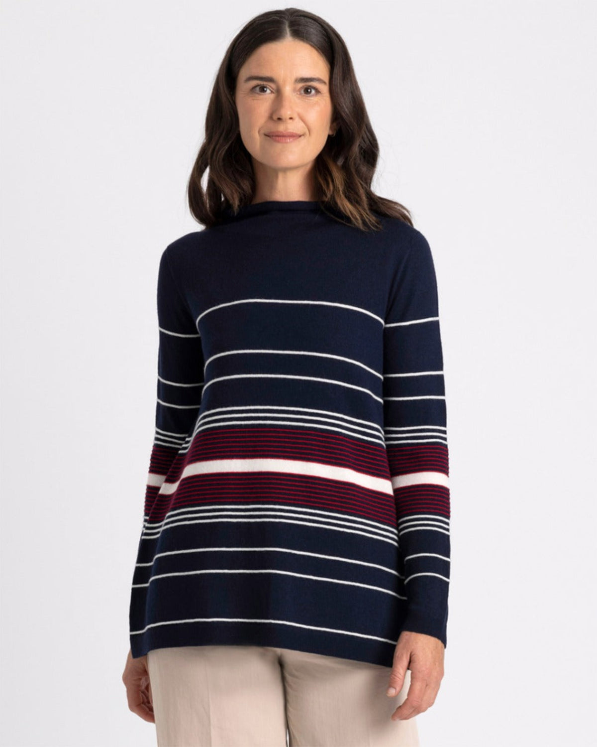 merino Woman wearing a navy blue sweater with red and white horizontal stripes on a white background