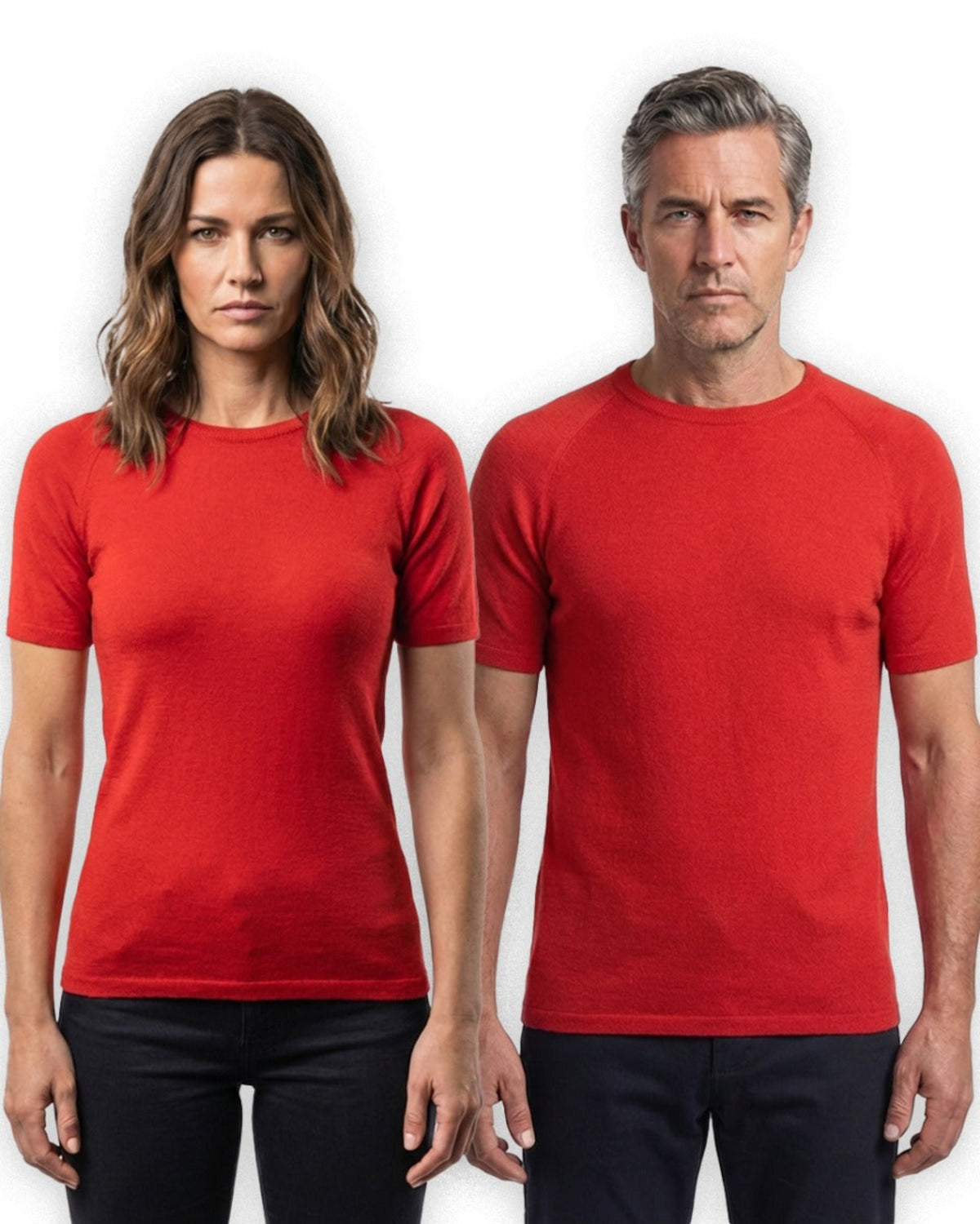 Two people wearing merino red t-shirts against a white background