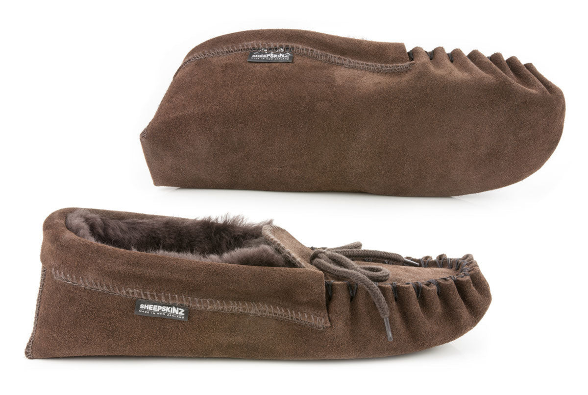 sheepskin Brown moccasin slippers with fur lining on a white background
