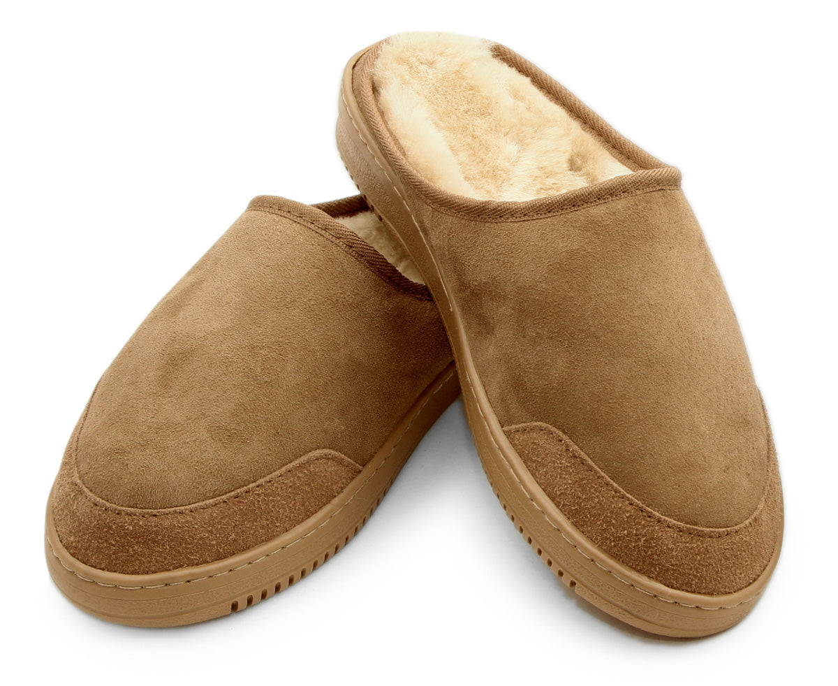 sheepskin clogPair of brown slippers with sheepskin lining on a white background