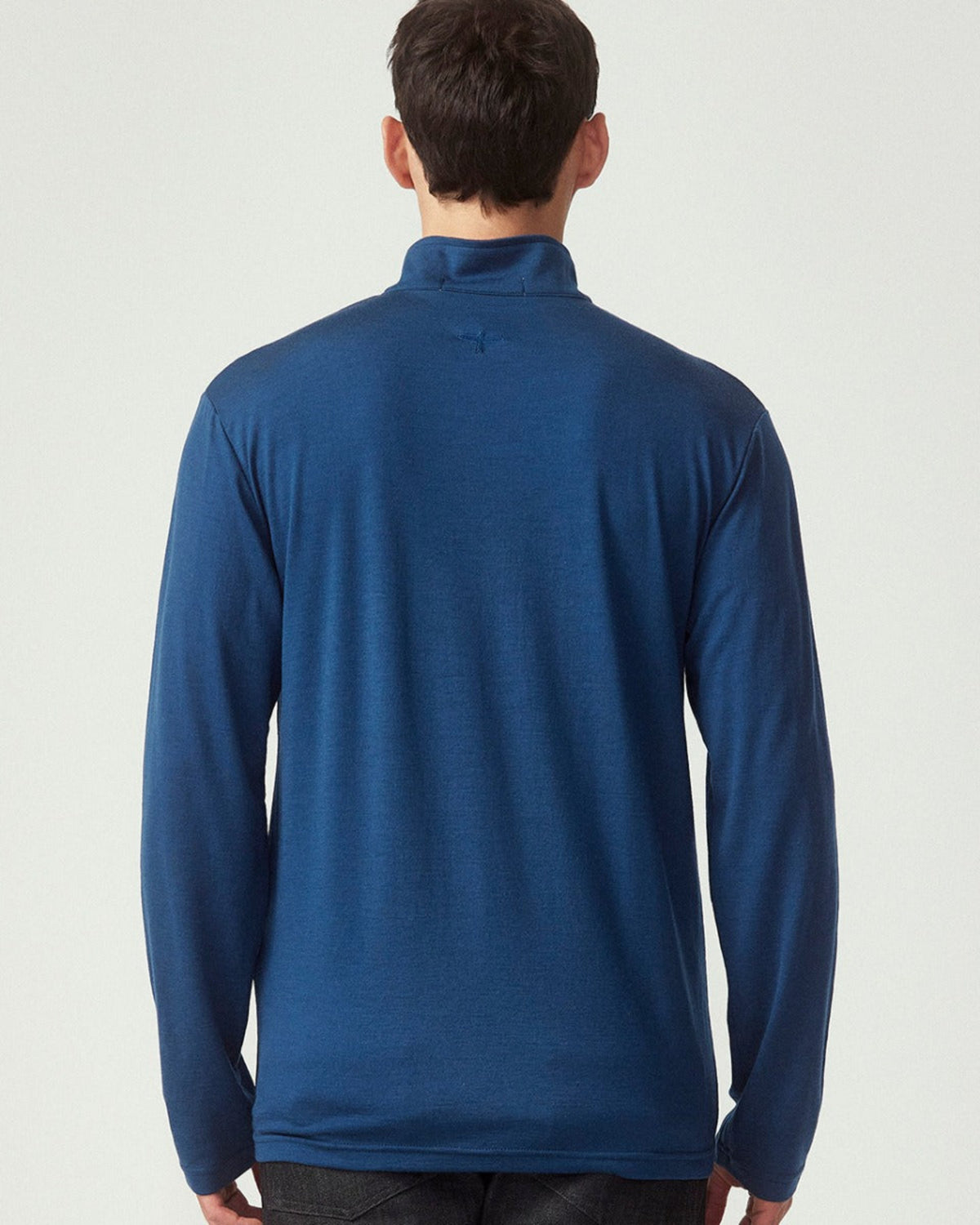 Merino Man wearing a blue long-sleeve shirt on a white background