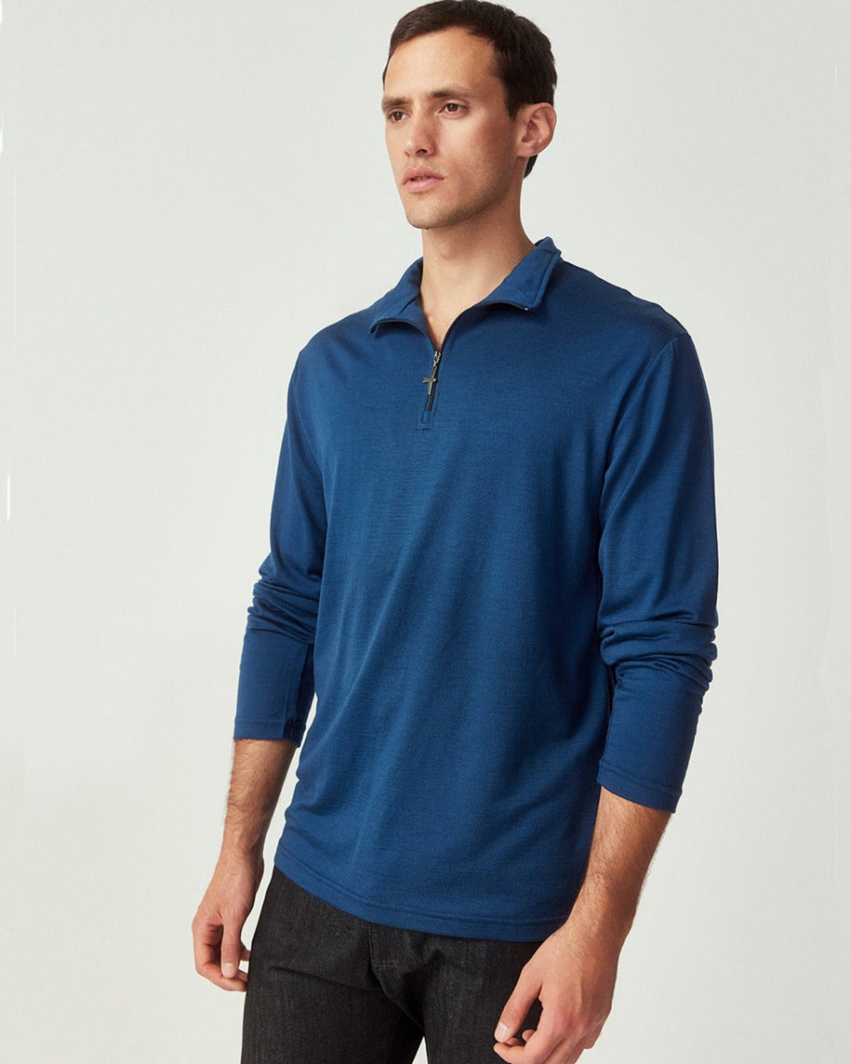 Merino Man wearing a blue long-sleeve shirt with a collar on a light gray background
