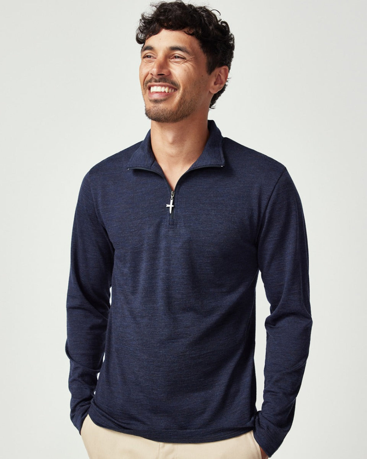 Merino Man wearing a navy long-sleeve shirt with a zipper on a light gray background