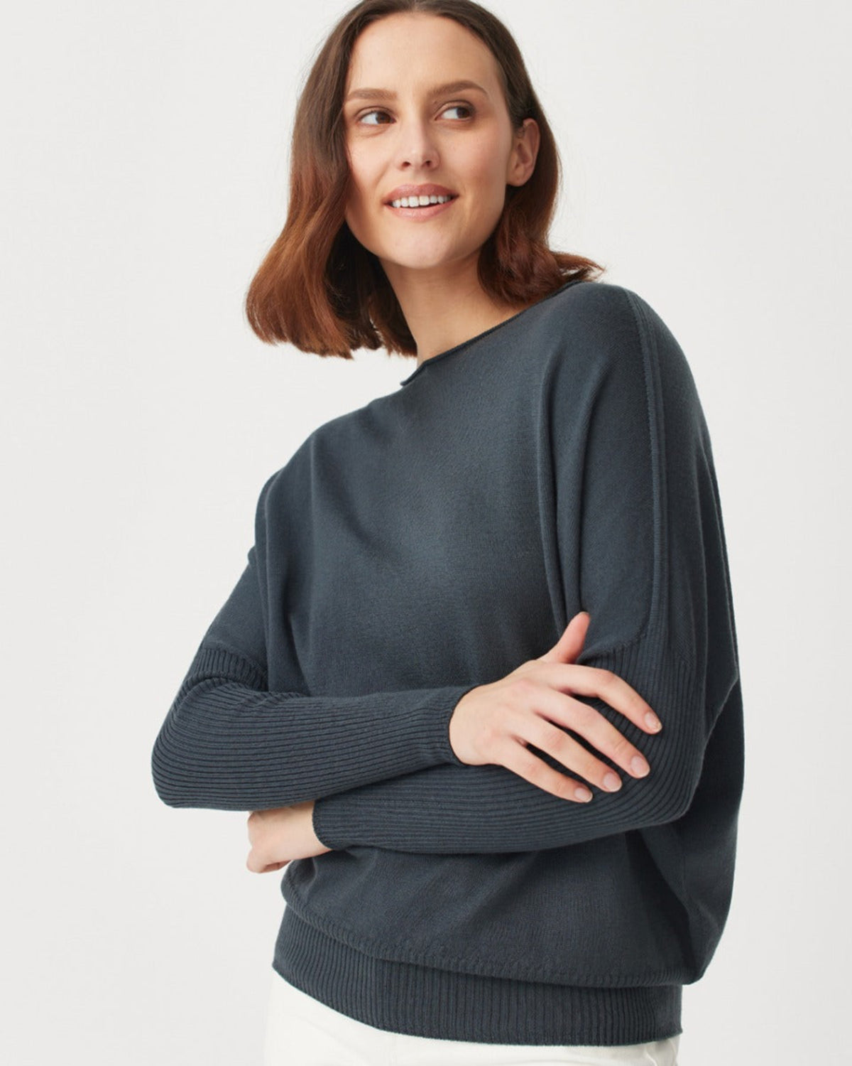Woman merino wearing a dark gray sweater on a white background