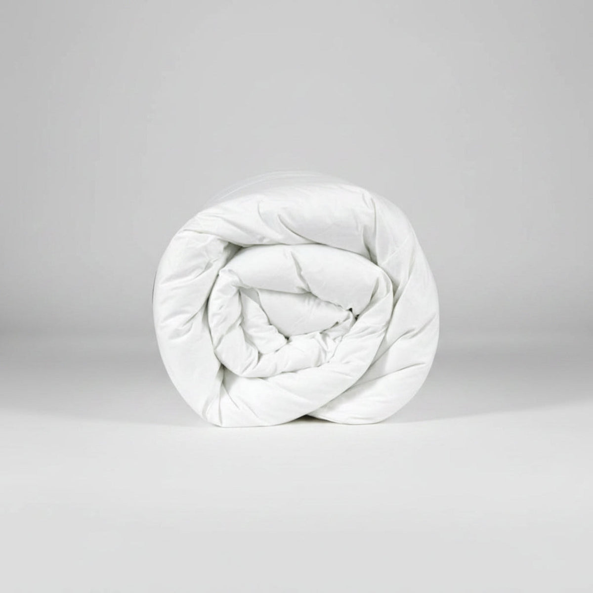 White silk quilted comforter on a white background