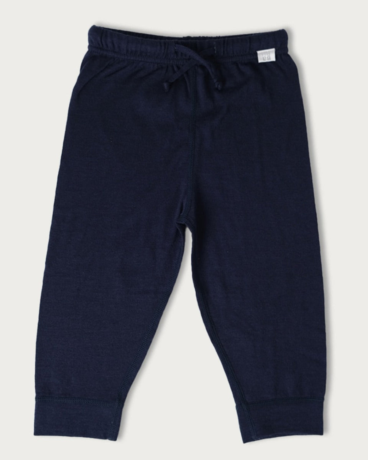Navy blue merino pants on a light gray background