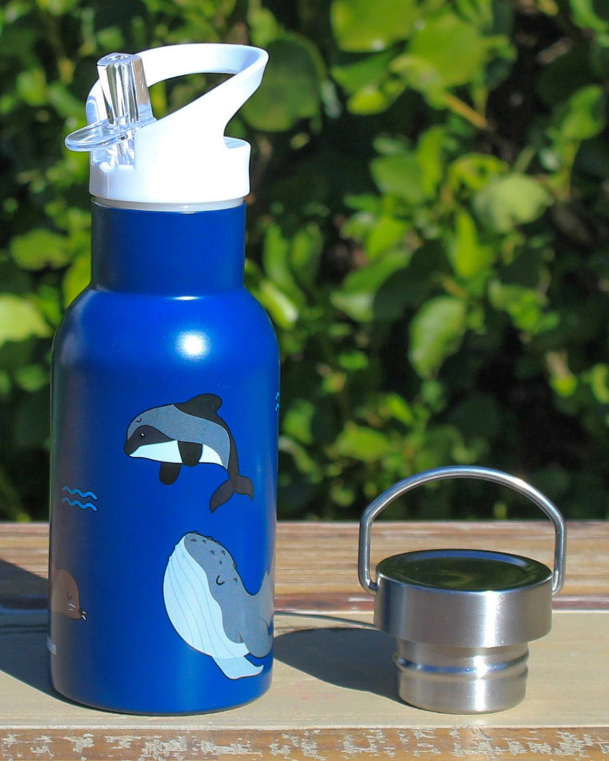 Blue water bottle with whale design on a stainless steel