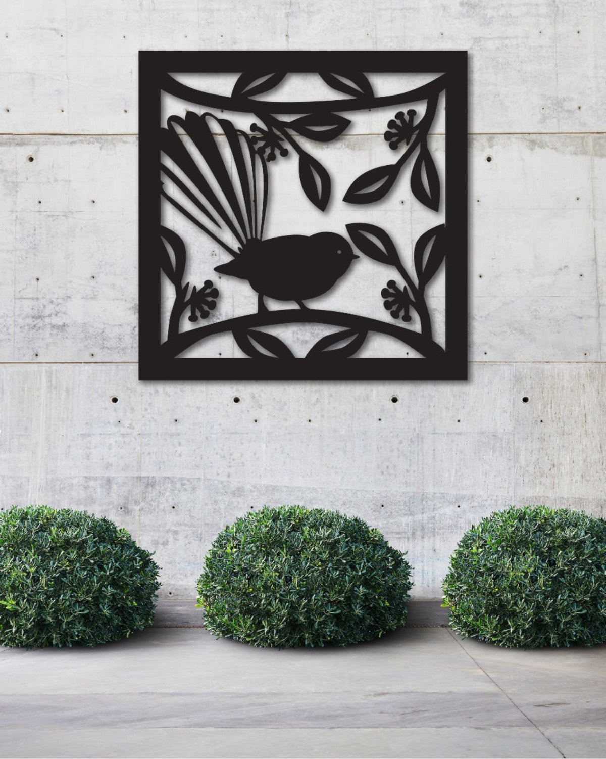 fantail Decorative metal wall art with a bird design on a concrete wall.