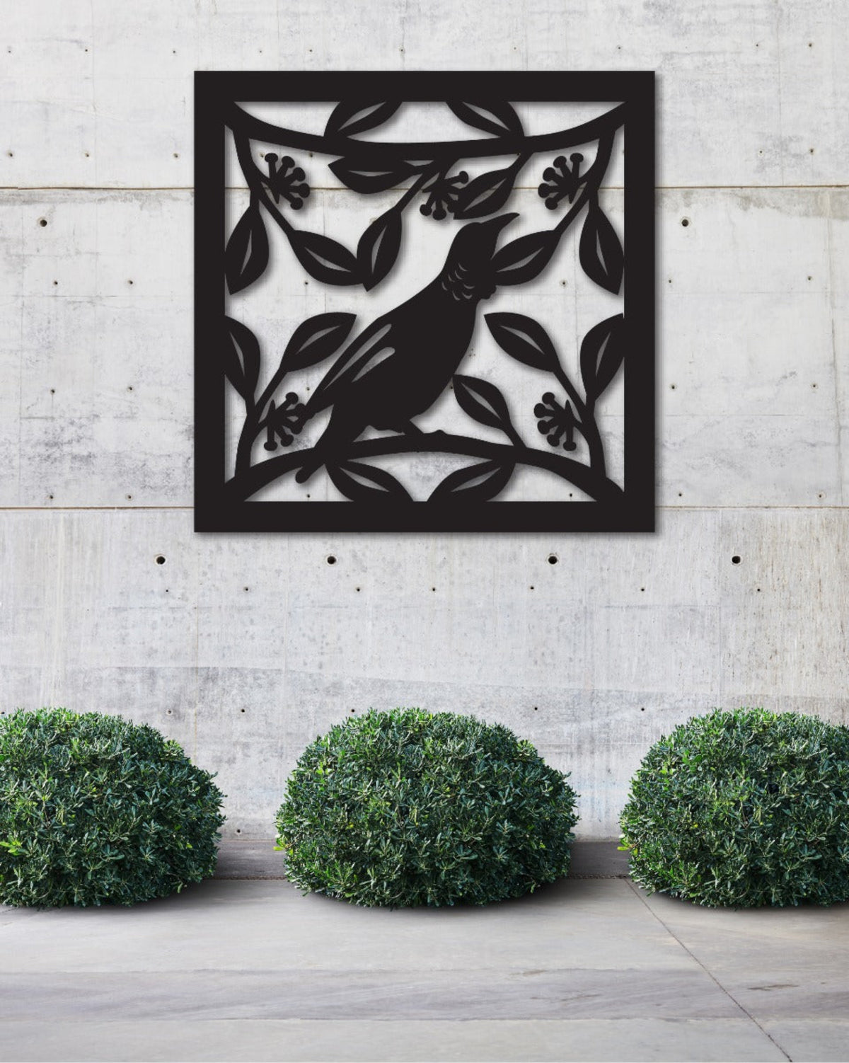 tui 
Decorative metal wall art with a bird design on a concrete wall.