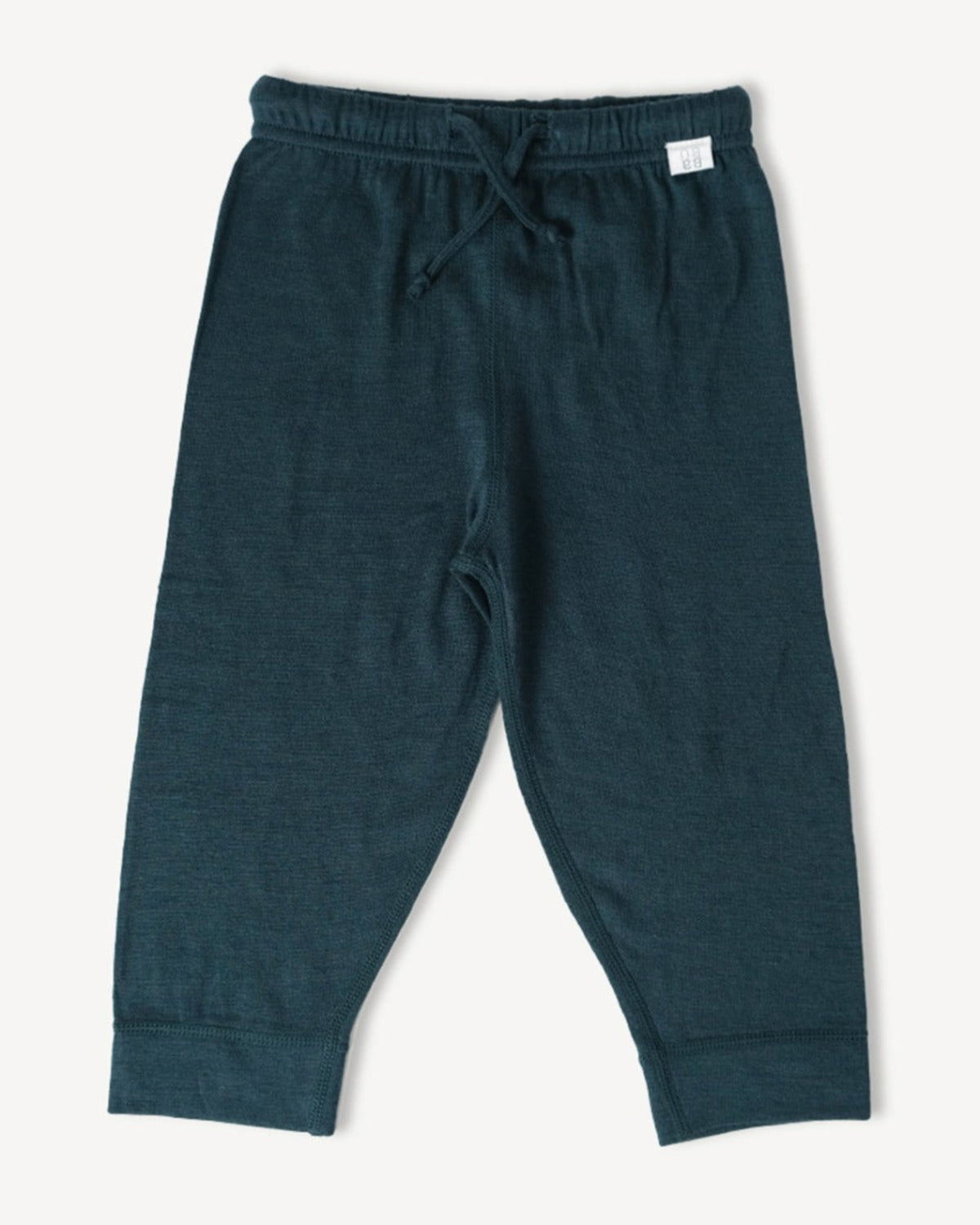 Dark green merino jogger pants on a light gray background