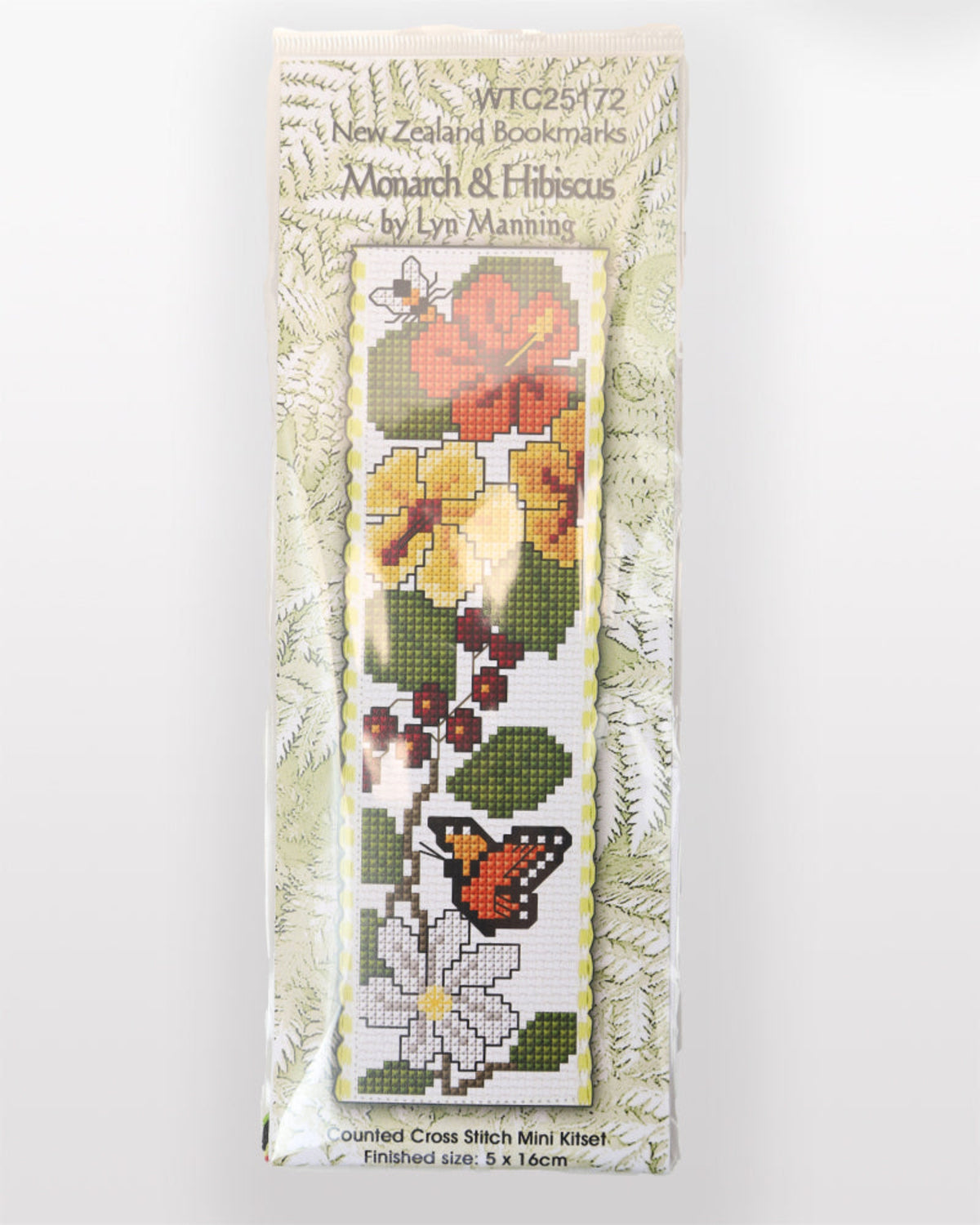 Cross-stitch kit packaging with floral design and butterfly on a white background