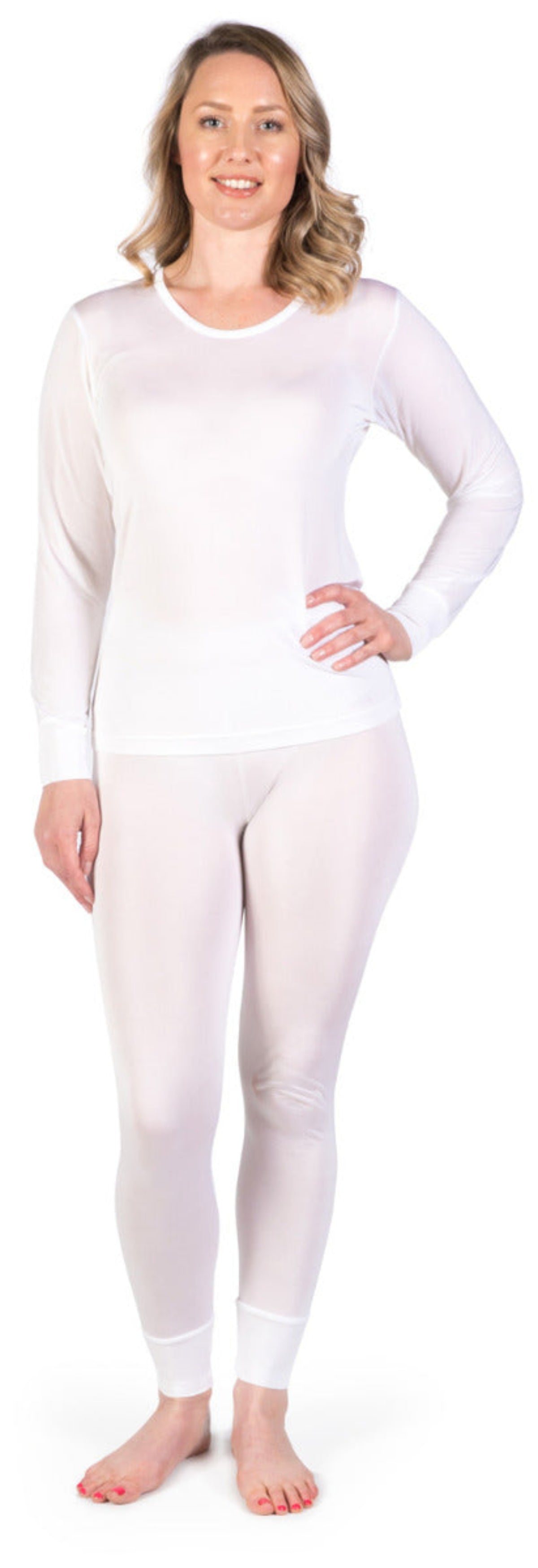 Woman wearing a silk white long-sleeve top and leggings