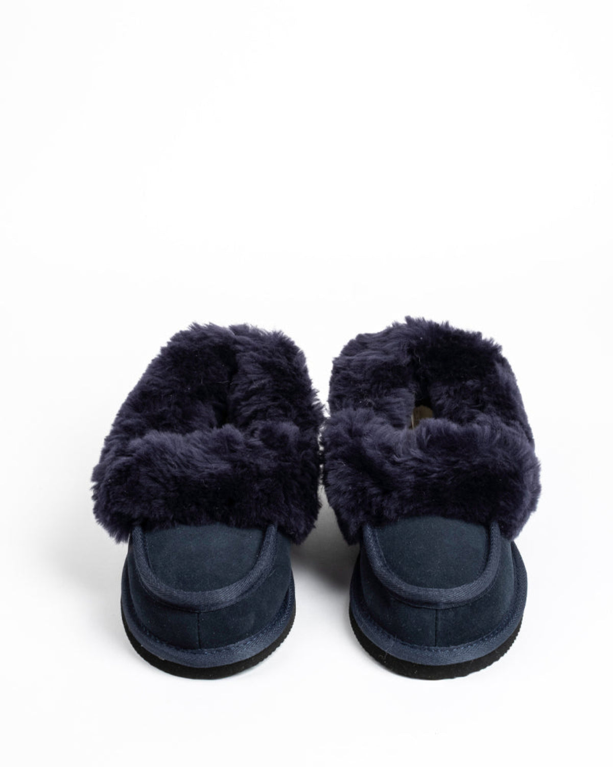 Pair of navy blue slippers with fluffy fur on a white background