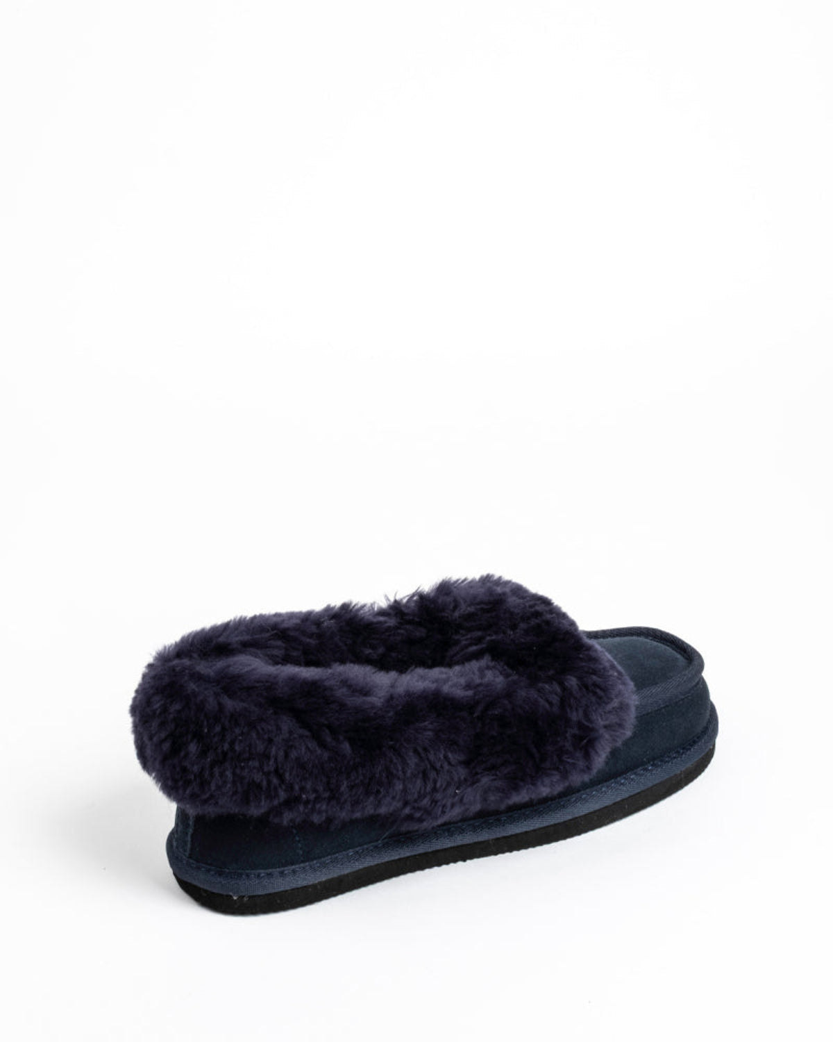Navy sheepskin slipper with fluffy fur on a white background