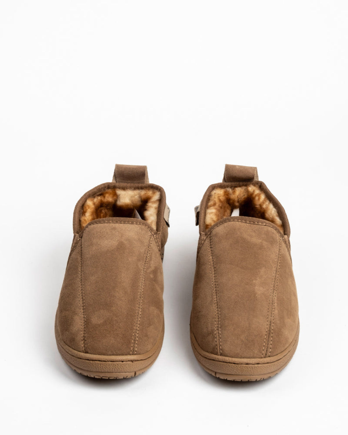 Pair of brown suede slippers with fur lining on a white background