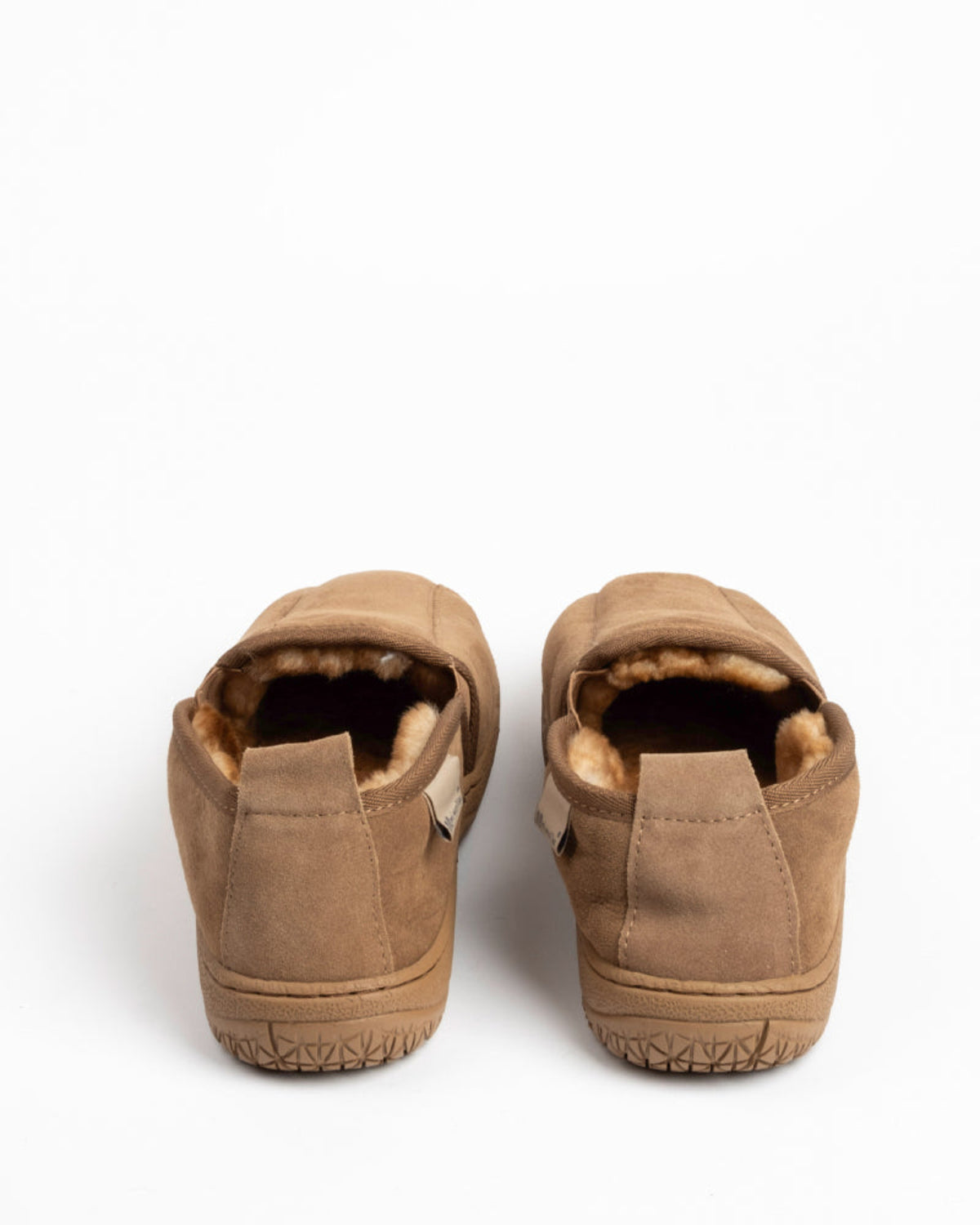 Pair of brown sheepskin slippers on a white background