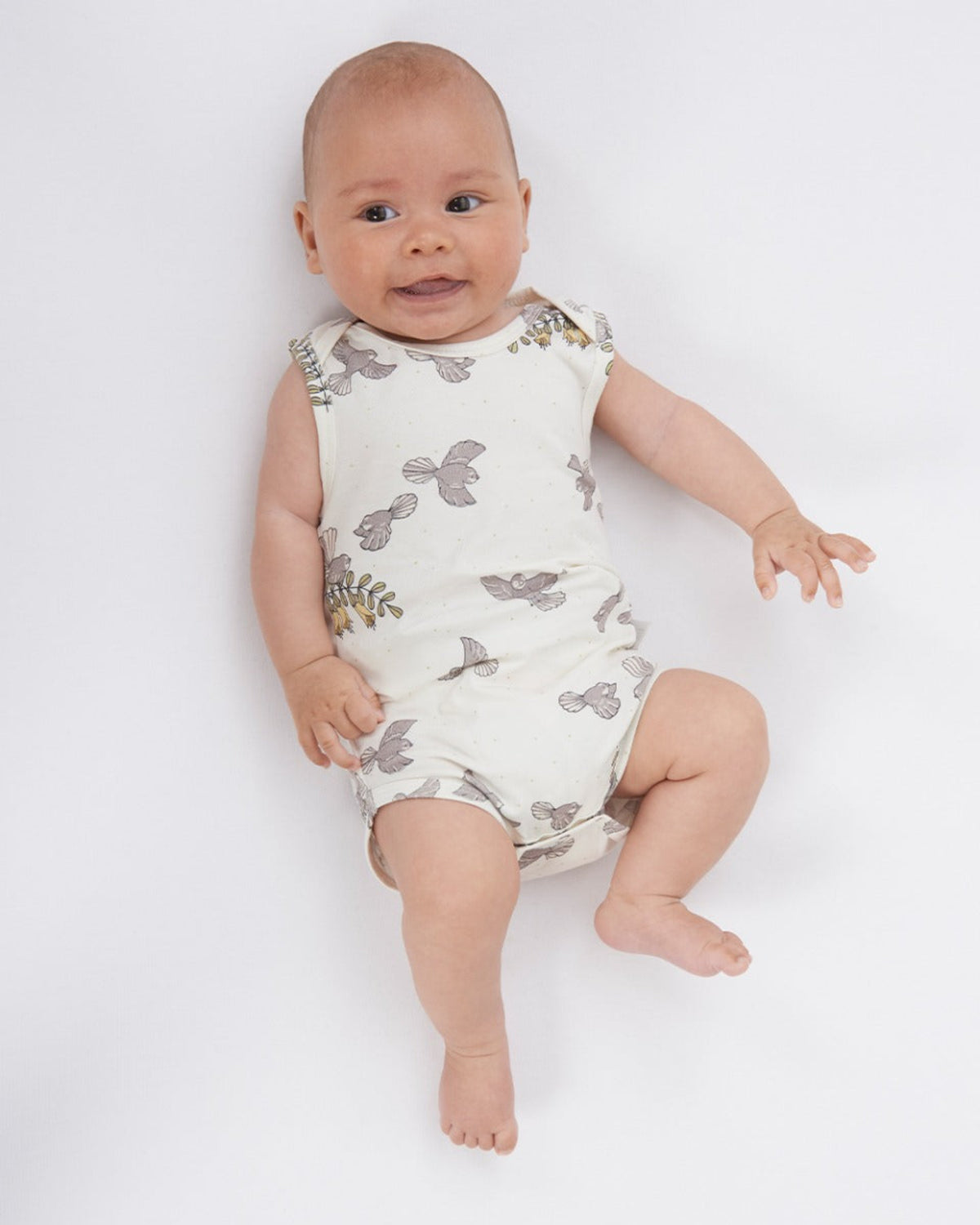 cotton organic singlet Baby wearing a sleeveless romper with butterfly pattern on a white background