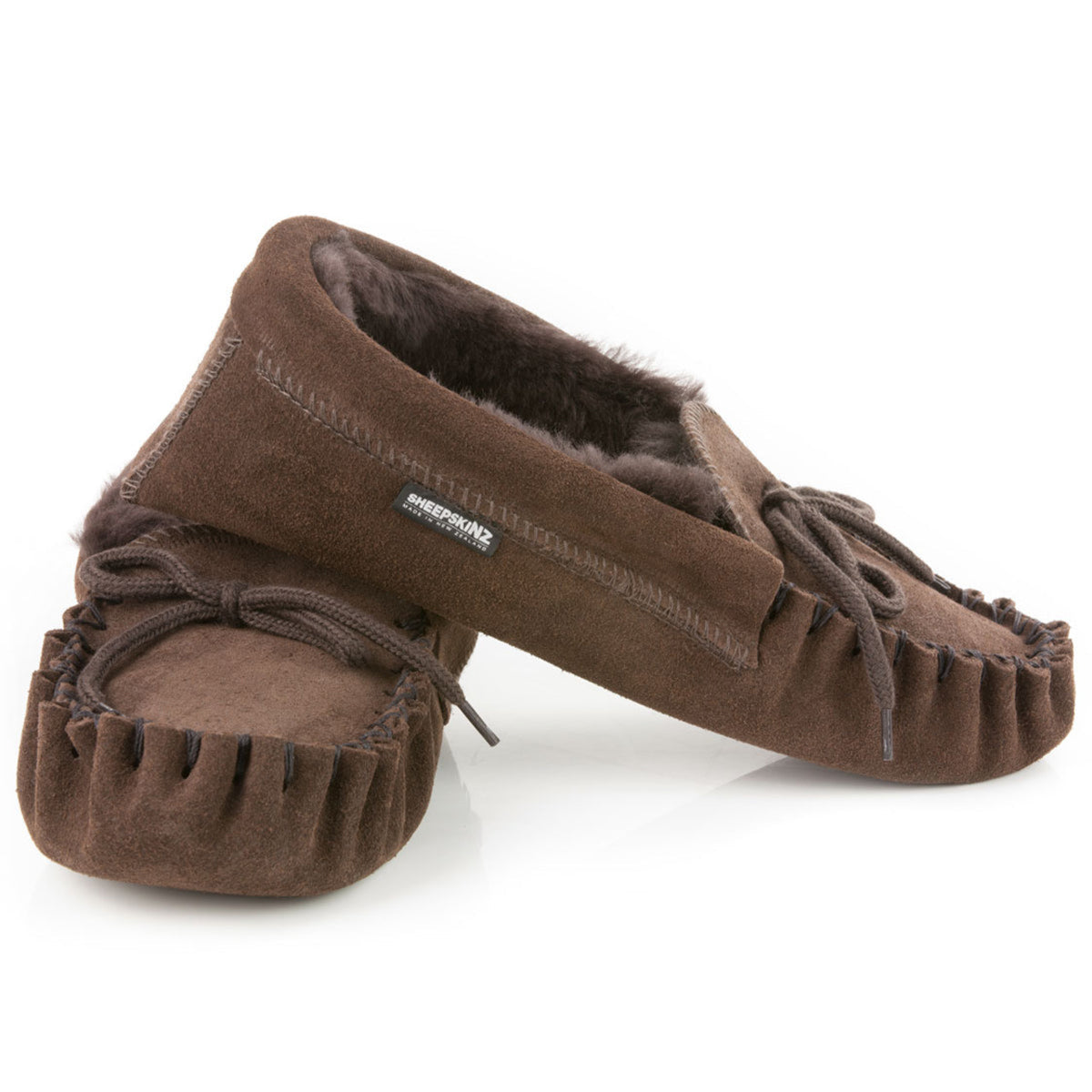 sheepskin Pair of brown moccasin slippers on a white background